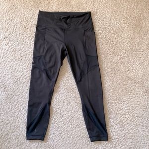 Compression yoga pants with pockets and mesh  cutouts.